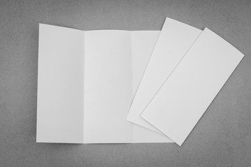 Trifold white template paper on gray background .