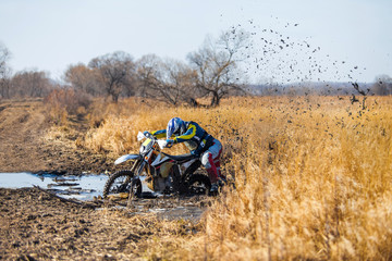 Enduro bike rider stuck in the mud