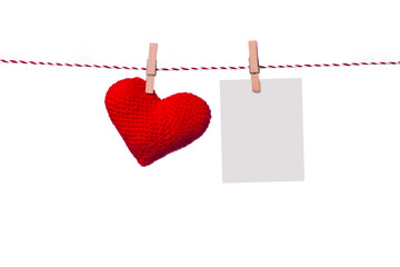 Colorful heart hanging on the clothesline on white background.