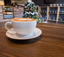 Delicious hot coffee in white cup on wooden table