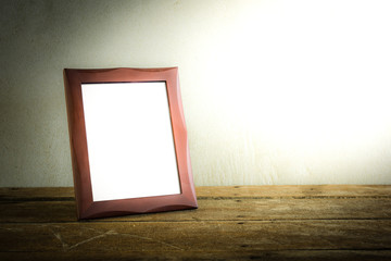 photo frame on wooden table over grunge background