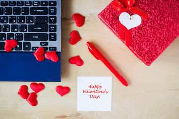 Happy Valentine's Day text written on sticker at table