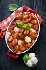 Potato gnocchi alla Sorrentina in a baking dish, high angle view