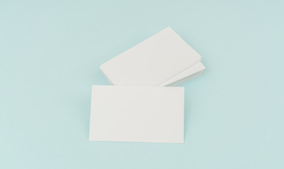 Blank business card on blue background .