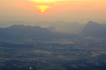 Blur sunrises over the mountain range and mist