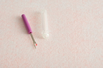 A purple stitch unpicker isolated on a white background