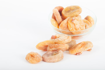 Dried figs in glass bowl on white background