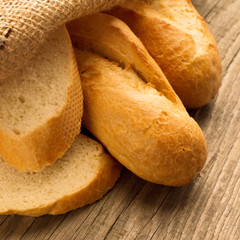 French baguette sliced on the wooden desk