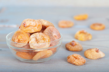 Dried figs in glass bowl on blue table