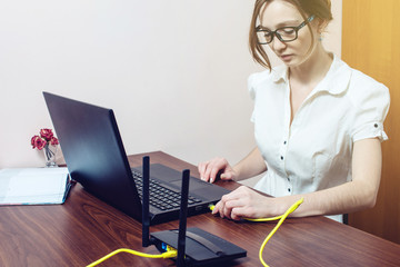 woman connect Internet cable to connector on the laptop