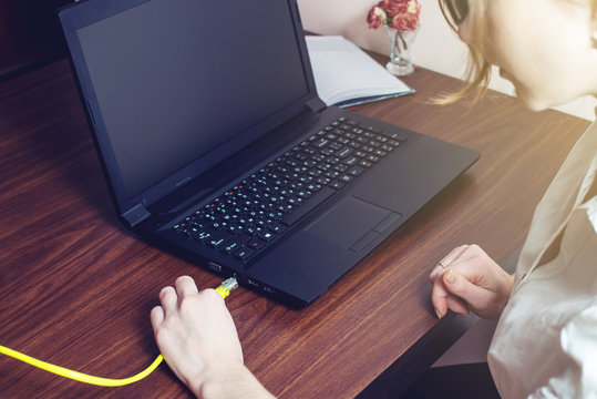 Woman Connect Internet Cable To Connector On The Laptop