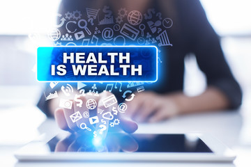 Woman is using tablet pc, pressing on virtual screen and selecting health is wealth.
