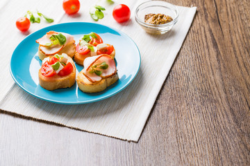 Bruschetta with tomato, cheese and bacon