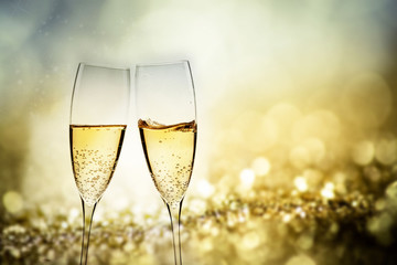 toasting with champagne glasses against holiday lights