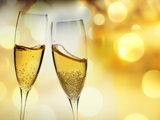 toasting with champagne glasses against holiday lights