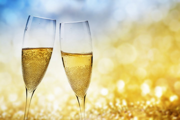 toasting with champagne glasses against holiday lights