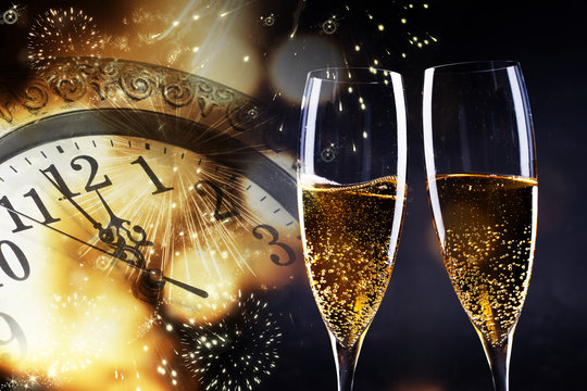 toasting with champagne glasses against holiday lights