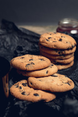 Chocolate cookie, biscuits on black table background. Close up