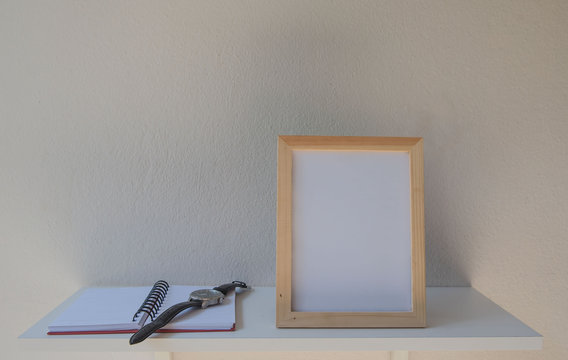 photo Frame on a wooden and book on White background .