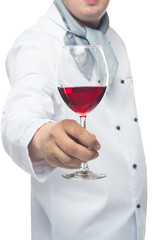 Chef holding glass of red wine in his hand on a white background
