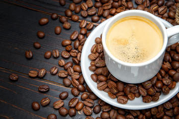 cup of coffee and beans on wooden background