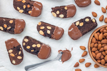 Homemade dark chocolate biscotti cookies with almonds, covered with melted chocolate, horizontal, top view