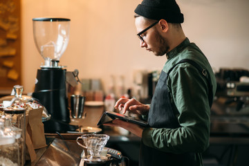 Barman making check in cafe