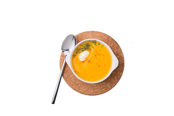 Pumpkin soup in white plate on  background
