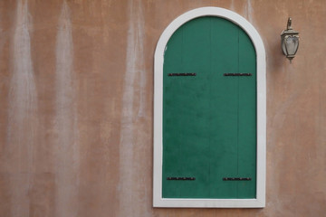Detail of an old wall with green front door