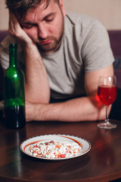 Alcohol addicted man has fallen asleep at a table