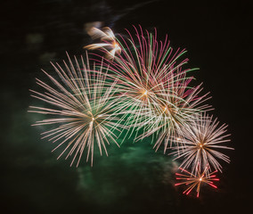 Brightly colorful fireworks  of various colors in the night sky