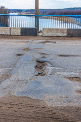 Potholes on the bridge. Bad road.