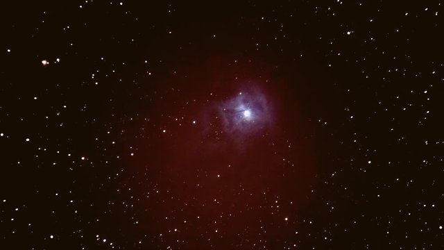 A 3D push-in shot of the Iris Nebula in space