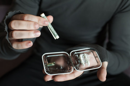 Addict Smells Cocaine From A Mirror Closeup.