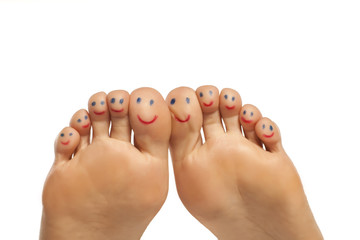 female foot and smiles drawn on the toes - obrazy, fototapety, plakaty