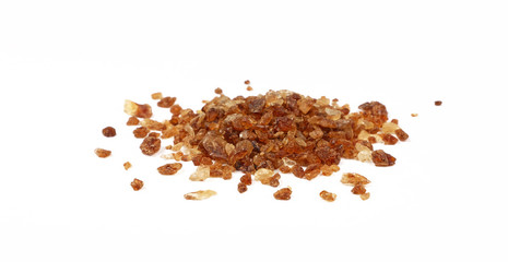 Pinch of brown caramel sugar spilled on white