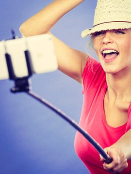 Tourist blonde woman taking pictures with phone