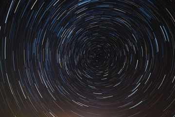 Obraz premium Night sky with multicolored starry tracks.