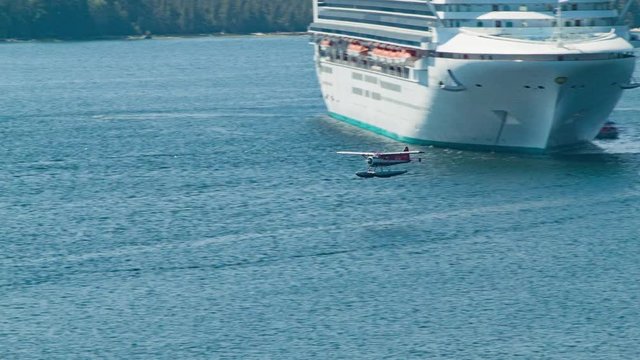 Seaplane Taking-off In Front of Cruise Ship Anchored while Calling in Ketchikan Alaska during the Summer Season Taking Passengers on an Air Sightseeing Excursion