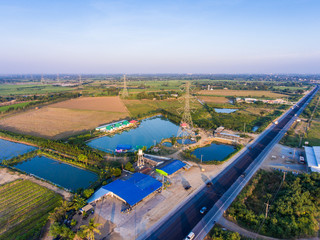 Aerial View of  Electricity Pole cross a Road in Countryside at