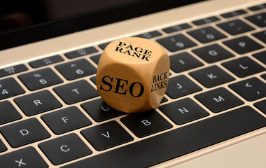SEO page ranking concept dice cube on laptop keyboard