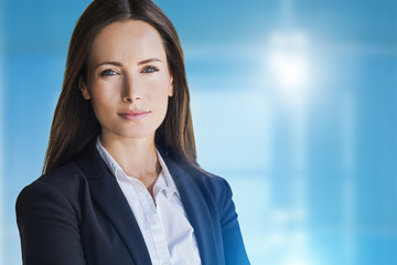 Prestige business woman close up. Advertising image with abstract blue background and copy space.