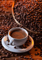 Cup of black coffee and roasted beans