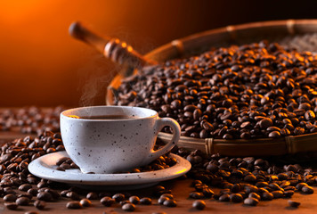 Cup of black coffee and roasted beans
