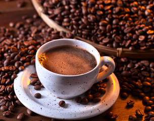 Cup of black coffee and roasted beans