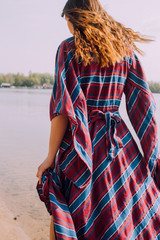 beautiful hippie girl walking near the shore girl in a dress, co