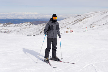 Fototapeta na wymiar happy man happy in snow mountains at Sierrna Nevada ski resort in Spain