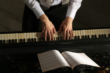 Man hands playing piano, close up © Africa Studio