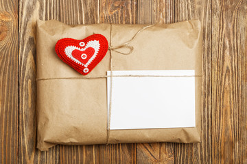 Gift parcel with white blank label and red heart