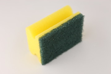 Yellow scoring sponge for cleaning on white background 